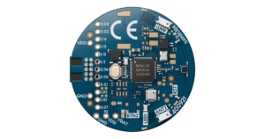 Front side of a round blue Nordic nRF54L15 tag circuit board with the N54L15 chip, push button, and antenna connectors